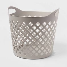 a gray basket with holes on the side and handles, sitting in front of a white background