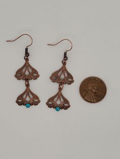 Antique Copper Veined Leafy Triangle Earrings in a swirly Art nouveau style are slightly dapped and connected by jump rings. At the bottom is a Swarovski crystal, round and green. Earrings dangle from ball and coil ear wires in antique copper finish. A Takeen Arts original. These match a bracelet on this site with the same links. Designed and created by TLP and staff for Takeen Arts. Item E1051. Antique Finish Copper Dangle Earrings, Antique Finish Copper Drop Earrings, Triangle Art, Art Nouveau Antiques, Art Nouveau Style, Triangle Earrings, Green Crystal, Green Earrings, Copper Finish