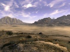 an image of a desert scene with mountains in the background