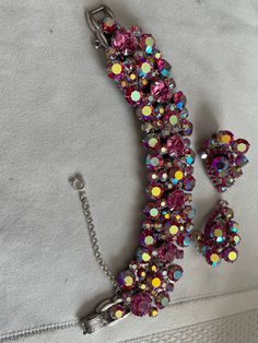 "This is an exquisite verified Juliana 5 link bracelet and a pair of matching clip on earrings that are not Juliana. The bracelet is 1 1/8\" wide and 6 1/2\" long. The earrings are 1 7/16\" long and 1\" wide. The pieces are all in excellent condition." Pink Clip-on Jewelry For Anniversary, Pink Crystal Bracelet For Formal Occasions, Pink Crystal Bracelets For Formal Occasions, Formal Pink Crystal Bracelet, Pink Clip-on Jewelry For Evening, Pink Sparkling Stones Jewelry Set For Party, Pink Party Jewelry Sets With Sparkling Stones, Anniversary Crystal Clip-on Jewelry, Pink Crystal Jewelry Sets For Formal Occasions