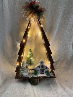 a small christmas tree with lights on it