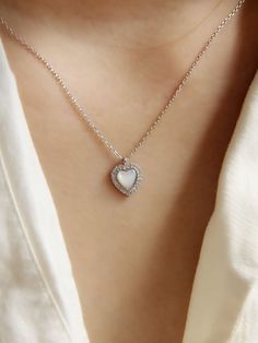 "* CZ White Shell Heart Pendant Necklace * This necklace is made from sterling silver, high quality CZ diamond and features a hear-shaped pendant with a white shell insert attached to a fine chain. This minimalist-style necklace which looks great both combined with other chain necklace or on its own. This necklace is truly timeless and suitable for any everyday wear. You will love to wear yourself or give as gift.  The perfect gift for an anniversary, birthday, engagement, a graduation, bridesmaid gift, Christmas, or any other occasion. Material: 925 Sterling Silver   Finish: 925 Sterling Silver  Chain: 16\"  Pendant Size: 10mm x 10mm  Package: All jewelry will arrive tastefully packaged making it a perfect gift.  Category: Shell Pendant, Seashell Necklace, Shell Necklace, Natural Shell, S Delicate White Heart Pendant Jewelry, White Heart Necklace For Wedding, Delicate White Heart-shaped Necklace, Delicate White Heart Necklace, White Heart-shaped Minimalist Jewelry, Minimalist White Heart-shaped Jewelry, White Sterling Silver Necklace With Heart Charm, White Minimalist Jewelry With Heart Charm, Delicate White Heart Pendant Necklace