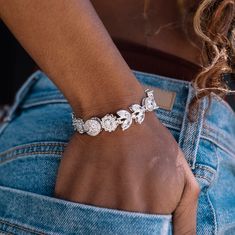 Ice out your wrist with the Diamond Flower Bracelet in 14k White Gold. This piece is meticulously crafted, featuring an intricate pattern of bold hand-set stones and finished with a unique hidden clasp. To open the bracelet, find the circle with GLD stars, and slide the magnetic closure up or down for easy on and off. Step up your style game with this exclusive piece, it's perfect to pair with any fit anywhere you go. This product is guaranteed for life – GLD will repair or replace the item shou Luxury Flower Shaped Jewelry With Diamond Accents, Luxury Flower-shaped Jewelry With Diamond Accents, Wedding Jewelry With Diamond Accents In Flower Shape, Wedding Jewelry With Diamond Accents And Flower Shape, Exquisite Flower Shaped Jewelry With Diamond Accents, Flower-shaped Wedding Jewelry With Diamond Accents, Exquisite Flower-shaped Jewelry With Diamond Accents, Formal Jewelry With Diamond Accents And Flower Shape, Formal Flower Shaped Jewelry With Diamond Accents