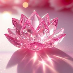 a pink crystal lotus flower sitting on top of a table