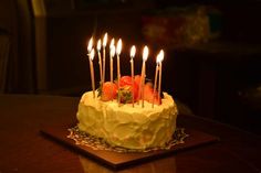 a cake with candles on it sitting on top of a table