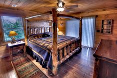 a large bed sitting inside of a bedroom next to a window