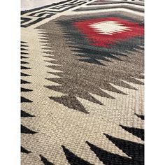 an area rug with black, white and red designs