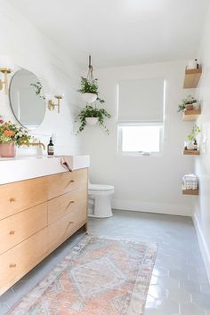 a bathroom with a rug, sink and toilet in it's centerpieces