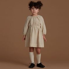 This dress is made from soft, comfortable cotton and has a pleated skirt that adds a touch of style. It is perfect for everyday wear and would also make a great choice for special occasions. The dress comes in a variety of sizes to fit girls from 13 months to 6 years old. Specifications: Style: Casual Sleeve Style: Regular Sleeve Length: Long Silhouette: A-Line Season: Spring & Autumn Pattern Type: Solid Material: Cotton Gender: Girls Fit: Fits true to size, take your normal size Dresses Length: Cream Pleated Dress For Fall, Beige Cotton Smock Dress, White Cotton Dress With Pleated Waist, Fall Long Sleeve Pintuck Dress, Casual Pleated Cream Dress, Casual Cream Pleated Dress, Cute Beige Cotton Dress, Cotton Pleated Dress For Daywear, Long Sleeve Cotton Pleated Dress