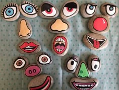 some kind of rock art with different faces painted on it's face and eyes