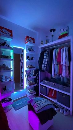 a bedroom with blue lights and clothes on the closet shelves in front of the mirror