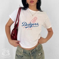 Vintage LA Dodgers Retro Baby Tee  💕 ABOUT - The same baby-tee fit you know & love! - Super comfortable and soft material. - 100% sustainably sourced ring-spun cotton, coloured with OEKO-TEX certified low-impact dyes. - All t-shirts come with pearlized, tear-away labels for total comfort and a scratch-free experience. 🌟SIZING - Please find the size chart in the description before purchasing. 💖CARE/ WASH - Machine wash: warm 30C (max 40C or 105F) - Non-chlorine bleach as needed - Tumble dry: l Short Sleeve Cropped T-shirt With Letter Print For College, Cropped Short Sleeve Letter Print T-shirt For College, Cropped Short Sleeve T-shirt With Letter Print For College, Cropped Letter Print T-shirt For College, Sporty White Slogan Top, Sporty White Top With Slogan, Graphic Print Cropped Cotton T-shirt For College, Graphic Print Cotton Cropped T-shirt For College, Casual Cropped T-shirt With Letter Print For College