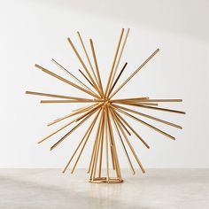 a sculpture made out of sticks sitting on top of a table