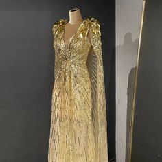 a gold dress with sequins on it and a mirror in the back ground