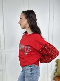 Feeling merry and bright this holiday season?! Then The Be Merry Top from White Birch is for you! It features long embellished sequin sleeves, round neckline, straight hemline, "Merry" across the front in sequin embellishments and a oversized loose fit. The fabric is thicker than your typical tee shirt material and a little more lightweight than your typical sweatshirt. Pair with our "Grounded Warrior Leggings" for something more casual and laid back or pair with our "Lovervet Take Me Higher Hig Christmas Sequin Top For Festive Occasions, Christmas Sequin Tops, Sequin Top For Christmas Holiday, Fall Holiday Tops With Sequins, Winter Tops With Contrast Sequin, Winter Contrast Sequin Tops, Holiday Sequin Tops For Fall, Sequin Tops For Fall Holiday, Holiday Sequin Tops For Party Season