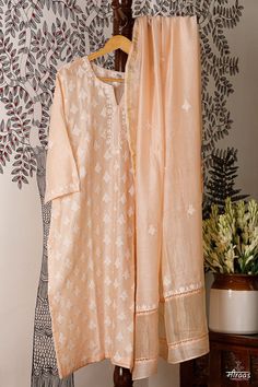 Regal Peach coloured Boteh (boota) Kurta Dupatta set with running floral motif on the front body. The back has small floral bootis to give an overall neat look to the ensemble. A Chanderi dupatta matches the floral bootis on the body the kurta back. Lace detailing adds to the beauty of the ensemble. Stitching of the Kurta is complimentary by Meiraas, along with cotton detachable slip. We have just 1 piece in this ensemble that can be made from S - XXL, so leave your size in the Customer Note, as per our size chart given. The Sustainability Quotient (SQ): 1. Skilled Resham Hand Embroidery 2. Antique hand carved wooden hand block motif printing, following all processes 3. Handloom Chanderi fabric ARTISANAL CHIKANKARI BY MEIRAAS KHAYAL (moodboard): Boteh or Boota is the backbone of the crafts Luxury Bohemian Dupatta With Chikankari Embroidery, Festive Semi-stitched Cutwork Kurta, Sharara With Chikankari Embroidery And Straight Kurta In Chanderi, Chikankari Embroidered Jamawar Lawn Suit, Festive Salwar Kameez With Chikankari Embroidery In Slub Silk, Elegant Slub Silk Lawn Suit With Chikankari Embroidery, Unstitched Straight Kurta In Slub Silk With Intricate Embroidery, Transitional Chanderi Sets With Chikankari Embroidery, Festival Lawn Suit With Chikankari Embroidery On Slub Silk