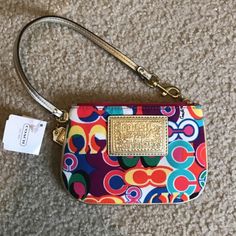 Coach Pop C Multi Color Signature Wrislet Wallet F48151 Special Features: Bright Gold Lurex/Metallic Leather Piping, Trim & Wrist Strap. Strap Measures 14" From End To End With A Brass Dog Leash / Spring Clip At One End. The Multi-Color Poppy Pop C Signature Denier Nylon Fabric Is Beautiful! Coach & Poppy Embossed Rectangular Logo Sewn On Front. * Imported From : Usa * Exterior: The Multi-Color Poppy Pop C Signature Denier Nylon Fabric Is Beautiful! Coach & Poppy Embossed Rectangular Logo Sewn Multicolor Coach Clutch Bag, Coach Multicolor Clutch Bag, Coach Multicolor Travel Wristlet, Coach Multicolor Wristlet For Travel, Multicolor Coach Wristlet For Travel, Compact Multicolor Travel Bags, Multicolor Coach Bag With Zipper Closure, Multicolor Zipper Pouch Wristlet, Multicolor Wristlet Clutch With Zipper