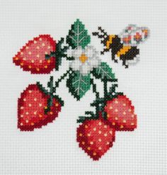 the cross stitch pattern shows three strawberries with flowers and two bees on them,