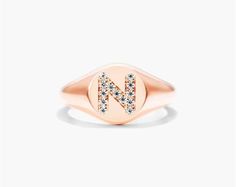 14K Rose Gold Diamond N Initial Signet Ring. This timeless ring will dazzle all who see it. Perfect for any age and occasion, this ring makes the perfect individualized gift! Rose Gold Oval Initial Fine Jewelry Ring, Rose Gold Oval Initial Ring Fine Jewelry, Oval Rose Gold Initial Ring Fine Jewelry, Fine Jewelry Rose Gold Oval Initial Ring, Rose Gold Polished Finish Signet Ring, Luxury Rose Gold Signet Ring With Brilliant Cut, Rose Gold Polished Finish Round Cut Signet Ring, Fine Jewelry Rose Gold Signet Ring For Anniversary, Rose Gold Round Cut Signet Ring Fine Jewelry