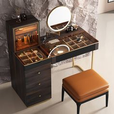 a dressing table with a mirror, stool and jewelry box on it in front of a stone wall