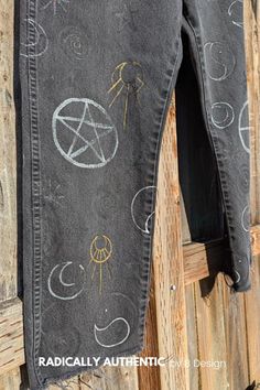 Pants full of good witch symbols. Yin and Yang in black and white, Rising Woman in gold, Moons in silver, Stars in sparkle, Spirals in Glow-In-The-Dark, Pentagrams in black and a Pentacle and Solar Cross in silver. Whether you enjoy the Halloween season or are a witch are year long, get your pants upgraded to these Witchy Pants. This listing is for a custom painted design (not the actual pants shown) painted on your own clothing. Simply send me a pair of pants (made of natural materials like denim, cotton, linen or leather) and I will custom paint the Witchy Pants design, similar to the pictures shown, on YOUR OWN PANTS. Colors and symbols can be customized. This is a hand-made item so you get what you want! If you are wanting to radically alter the design, remove portions of the design or Witchy Pants, Solar Cross, Witch Symbols, Woman In Gold, Good Witch, Custom Painted, Pants Design, Halloween Season, Pair Of Pants