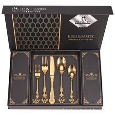 a set of five gold - plated flatware in a presentation box with matching utensils