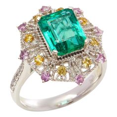 This ring designed by David Jerome is from his private collection and features one Emerald cut Emerald sourced in the chivor mine in Columbia totalling 3.03cts. Set with a mix of round brilliant cut Diamonds, pink and yellow Sapphires totalling 0.78cts combined. Mounted in platinum. Ring size UK N, EU size 54, USA size 6 1/2. Complete with Xupes presentation box. Our Xupes reference is DJ0116 should you need to quote this. David prides himself in only sourcing the finest and most exclusive gemst Sapphire Cluster Ring, Square Stone, Jewels Rings, Contemporary Ring, Royal Jewels, Platinum Ring, Pretty Rings, Vintage Jewels, Pink And Yellow