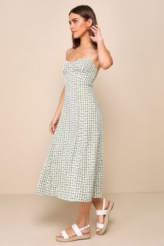 Looking absolutely darling is what the Lulus Daytime Sweetie Green Gingham Embroidered Halter Midi Dress is all about! Lightweight woven fabric boasts a green and white plaid pattern and delicate floral eyelet embroidery throughout as it shapes a sleeveless, sweetheart bodice with seamed cups and slender straps that create a tying halter neckline. The figure-skimming silhouette falls to an A-line midi skirt that features godet details that create a subtle flaring effect. A smocked panel at the b Green Casual Dress For Picnic, Casual Green Dress For Picnic, Spring Plaid Sundress, Green Spring Picnic Dress, Plaid Dress For Spring Garden Party, White Plaid Dress For Picnic In Spring, White Plaid Dress For Spring Picnic, Gingham Plaid Midi Dress For Picnic, Spring Sundress In Plaid Midi Length