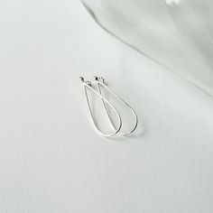 "This long Argentium sterling silver raindrop earring, while it is simple, is quite striking.  Easy and elegant, this pair of earrings has wonderful proportions and a beautiful shape.  The wire is left round , really giving them a soft look. These earrings will complete your look, whether dressing up for a night on the town, or they will look just as great with jeans and a T.  This versatile pair will make a great addition to your collection. Approximately 1-5/8\" Long x 5/8\" Wide Each pair is Sterling Silver Midi Rings, Elegant Hat, Midi Rings Silver, Silver Bridal Earrings, Dainty Hoop Earrings, Open Cuff Bracelet, Swarovski Crystal Earrings, Wedding Jewelry Earrings, The Wire