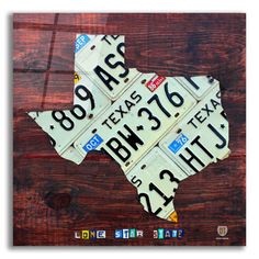 a map made out of license plates on top of a wooden table with the word texas written