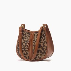 Upgrade Your Style with the Leopard Saddle Shoulder Bag Elevate your fashion game with our Leopard Saddle Shoulder Bag, crafted from premium microfiber leather for a luxurious feel. Designed for the modern woman, this bag combines functionality with trend-setting style, making it the perfect accessory for any occasion. Product Features Microfiber leather upper for durability and a sleek look Polyester lining material for added strength and resilience Zipper closure for secure storage of your essentials Bow decoration adds a touch of charm and femininity Spacious interior with an interior slot pocket for easy organization Available in classic Black or versatile Brown Benefits You'll Love Elevated Style: Stand out from the crowd with the chic leopard print design and sleek saddle shape of th Round Bags, Leopard Bag, Leopard Fashion, The Leopard, Round Bag, Leather Pattern, Types Of Bag, Sleek Look, The Chic