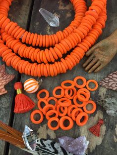 an assortment of orange beads and other items on a table