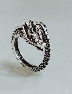 Discover the Awesome Style Retro Dragon Ring - a unique statement piece that is sure to turn heads. This intricately designed ring features a stylized dragon motif in a retro-inspired design, crafted from high-quality sterling silver. The intricate details of the dragon are exquisitely etched into the silver, giving the ring a striking yet elegant appearance. Overview: 100% new design and high quality Must-have for fashion women Have a beautiful appearance Specifications: Material: Copper Style: Goth Ring, Boyfriend Gifts Long Distance, Peacock Ring, Ancient Dragon, Serpent Ring, X Ring, Vintage Dragon, Dragon Ring, Copper Style