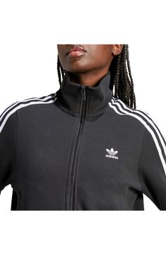 Made from a blend of cotton and recycled yarns, this ribbed track jacket with the 3-Stripes will keep you both comfy and sporty. Front zip closure Stand collar Front welt pockets 79% cotton, 21% recycled polyester Machine wash, dry flat Imported Fall Sports Track Jacket With Three Stripes, Fall Sportswear Track Jacket With Three Stripes, Spring Sportswear Track Jacket With Ribbed Cuffs, Fall Track Jacket With Three Stripes Branding, Fall Track Jacket With Three Stripes, Sporty Track Jacket With Three Stripes For Fall, Sportswear Track Jacket With Ribbed Collar For Fall, Athleisure Track Jacket With Ribbed Collar For Winter, Sporty Cotton Track Jacket For Fall