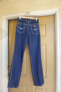 "This is a great pair of vintage Rene De France jeans. The Jeans have great contrasting stitching that really stands out against the blue denim and uniquely shaped backside. Labeled size 32 - 11 - please see measurements. Measurements taken across front laid flat Size Marked: 32 - 11 Waist: 14.5\" Hips: 20\" Inseam: 34\" Rise: 11\"" Retro Fitted Dark Wash Flare Jeans, Fitted Dark Wash Flare Jeans With Contrast Stitching, Retro Straight Leg Bottoms With Contrast Stitching, Medium Wash Retro Fitted Jeans, Retro Fitted Medium Wash Jeans, Vintage Fitted Denim Blue Flare Jeans, Fitted Vintage Denim Blue Flare Jeans, Vintage Fitted Flare Jeans In Denim Blue, Retro Dark Wash Rigid Denim Flare Jeans