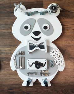 a white bear with a bow tie and glasses on it's face is surrounded by other items