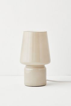 a white table lamp on a white surface