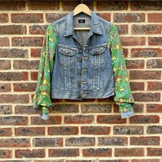 This custom jacket is a one of a kind piece crafted from thrifted denim. The jacket's back panel features a Mutant Ninja Turtles cutout.  The lower pockets and top pockets are both fully functional and it has metal snap buttons to close. This jacket is ideal for Mutant Ninja Turtles fans and vintage fashion lovers, and is sure to be a standout piece in any wardrobe. This is a thrifted 'Lee' denim jacket with the size missing, although it appears to be a small.  Note: this store uses thrifted den Retro Spring Denim Jacket With Patch Pockets, Fitted Recycled Denim Jacket With Pockets, Fitted Denim Jacket With Pockets In Recycled Denim, Fitted Long Sleeve Denim Jacket In Recycled Denim, Spring Upcycled Recycled Denim Jacket, Casual Fitted Denim Jacket With Patchwork, Reworked Recycled Denim Outerwear For Spring, Casual Fitted Patchwork Denim Jacket, Upcycled Long Sleeve Denim Jacket For Spring