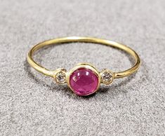 1. Diamond & Ruby 18k Gold Ring 2. Made to Order 3. Gemstone - Ruby, Diamond  4. Jewelry Type - Gold Ring 5. Total Weight - 1.040 Gram Approx. 6. Diamond Weight - 0.05 Carats  7. Ruby Weight - 0.55 Carats 8. Gold Weight - 0.920 Grams Approx.  9. Ruby Size - 4 MM 10. Gold Purity - 18k 11. Band Size - 1 MM 12. Handmade Items 13. AAA Quality Ring 14. Stackable Ring 15. 1 Quantity Available 16. Ready to dispatch in 1 - 2 days.  Pictures are taken under natural and day light. Yellow Gold Ruby Gemstones With Accents, Fine Jewelry Ruby Gemstones With Accents, Formal Ruby Ring With Bezel Setting, Gold Heirloom Ruby Ring With Gemstone Accents, Yellow Gold Ruby Ring With Round Stone, Heirloom Gold Ruby Ring With Gemstone Accents, Fine Jewelry Cabochon Ruby Ring In Yellow Gold, Fine Jewelry Ruby With Bezel Setting, Fine Jewelry Ruby Ring In Yellow Gold With Cabochon