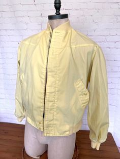 "Retro 80's mens lightweight jacket Lemon yellow jacket has 2 button pockets Metal zipper with 2 buttons at the bottom Stretch collar, cuffs and waistband Lined Size 40  Excellent condition Free shipping!! Measurements laying flat across; Chest - 24\" Sleeves - 23\" Length - 25\" Waist - 19\"" Vintage Outerwear For Spring, Retro Cotton Windbreaker For Spring, Fitted Windbreaker With Pockets For Spring, Retro Yellow Outerwear For Spring, Retro Windbreaker With Pockets For Spring, Spring Vintage Sport Coat With Pockets, Fitted Vintage Windbreaker For Fall, Vintage Spring Sport Coat With Pockets, Fitted Collared Sport Coat For Spring