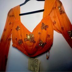 Hardly Worn. 100% Nylon. Free People Brand Hand Crafted Style From Bali. Perfect For Evermore/Folklore Or Barbieland! Fitted Orange Blouse For Party, Fitted Orange Party Blouse, Fitted Orange Blouse For Navratri, Spring Embellished Fitted Choli, Festive Floral Embroidered Top For Party, Bohemian Long Sleeve Choli For Party, Orange Embroidered V-neck Top, Embroidered Orange V-neck Tops, Bohemian Floral Embroidered Choli For Party