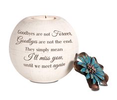 a ceramic candle holder with a blue flower on it and a poem written in cursive writing