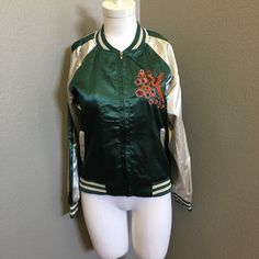 Embroidered Bomber Jacket Spring Varsity Jacket With Embroidered Graphics, Embroidered Green Outerwear For Streetwear, Green Embroidered Streetwear Outerwear, Green Long Sleeve Varsity Jacket For Spring, Green Embroidered Outerwear For Streetwear, Spring Outerwear With Embroidered Logo And Long Sleeves, Spring Long Sleeve Outerwear With Embroidered Logo, Embroidered Fitted Outerwear For College, Spring Embroidered Varsity Jacket With Long Sleeves