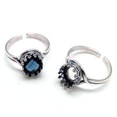 two silver rings with blue stones on each one and an oval stone in the middle