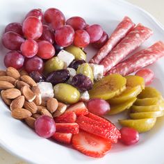 a white plate topped with fruit and nuts