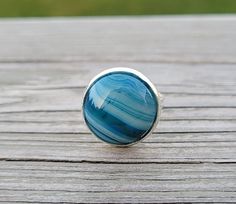 This silver colored ring makes a great gift!  It has a cabochon of blue and white striped agate.  The stone is 16mm. The ring is adjustable. Smallest is a 6 1/2. *SEE my store for cufflinks, tie clips, tie tacks, bracelets, & earrings. This would be a great gift for any time of the year! Perfect for a wedding, for a Christmas gift, anniversary gift, or a birthday. Please let me know if you have any questions. #es38 Handmade Blue Agate Rings, Purple Gifts, Puzzle Guest Book, Wood Guest Book, Paper Gifts Anniversary, Memory Locket, Bleu Violet, Tie Clips, Tie Tack