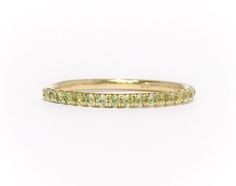 "Full Eternity Band Ring with U Micro Pave Set Natural Genuine Peridot. Material: Solid Gold (14K or 18K) Finish: High Polished /Shiny Fit: Comfort Fit (Rounded Interior) Width: 1.8 mm Height: 1.8 mm Setting Type: U Micro Pave (Reminds the letter\"U\") Stone: Natural Green Peridot Cut & Shape: Round, Diamond Cut Total Carat Size: apx 0.70+ ct Quantity of Stones: apx 38 (Varies by ring size) Quality: AAA Peridot has a unique shade of lime green that looks different green depending on inside/o Yellow Gold Stackable Rings With Peridot, Yellow Gold Peridot Stackable Rings For Anniversary, Stackable Yellow Gold Peridot Jewelry, Yellow Gold Peridot Stackable Rings For Wedding, Green Half Eternity Round Band, Green Stackable Eternity Band, Green Stackable Round Eternity Band, Yellow Gold Peridot Stackable Rings, Guard Ring