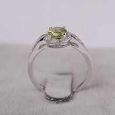 Ring details metal: silver/14k white(rose/yellow) gold center stone: Round shape 6x6mm (0.97ct) peridot accent stone: cz NOTE: if it is silver or white gold, it will be get plated with rhodium Customization is available you can change, add or remove any parts of the ring if you have good idea. I can add special engraving inside the shank of the ring by free (words, date, simply simbles and so on) too. I am happy to help out or make any adjustments to your order if you have a special request. Pro Peridot Birthstone Ring In White Gold, Elegant Peridot Birthstone Ring With Prong Setting, Lime Green Sterling Silver Promise Ring, Green Sterling Silver Round Diamond Ring, Green Sterling Silver Diamond Ring, Lime Green Sterling Silver Birthstone Rings, Elegant Lime Green Ring With Center Stone, Peridot Diamond Ring With Gemstone For Anniversary, Peridot Diamond Ring For May Birthstone