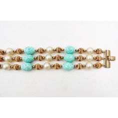 1960s goldtone resin faux-pearls and faux-turquoise speckled beads with fold over clasp. Marked "Napier." Measures: 8.25 inches long by 1.5 inches wide.  Condition: Very Good; wear to edges of beads, light wear to pearls. An identical bracelet is shown on pg. 360 of Melinda L. Lewis & Henry Swen's book "The Napier Co.: Defining 20th Century American Costume Jewelry. Vintage Turquoise Round Bead Bracelets, Vintage Blue Beaded Bracelets, Vintage Turquoise Beaded Bracelets, American Costume, Turquoise Bead Bracelet, Modern Branding, Turquoise Beads, Vintage 1960s, Fold Over