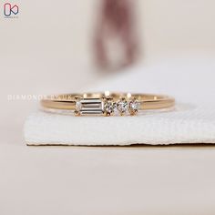 three diamond rings sitting on top of a white towel